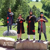 Itachi Uchiha practicing shadow cloning with Tobi watching in disapproval